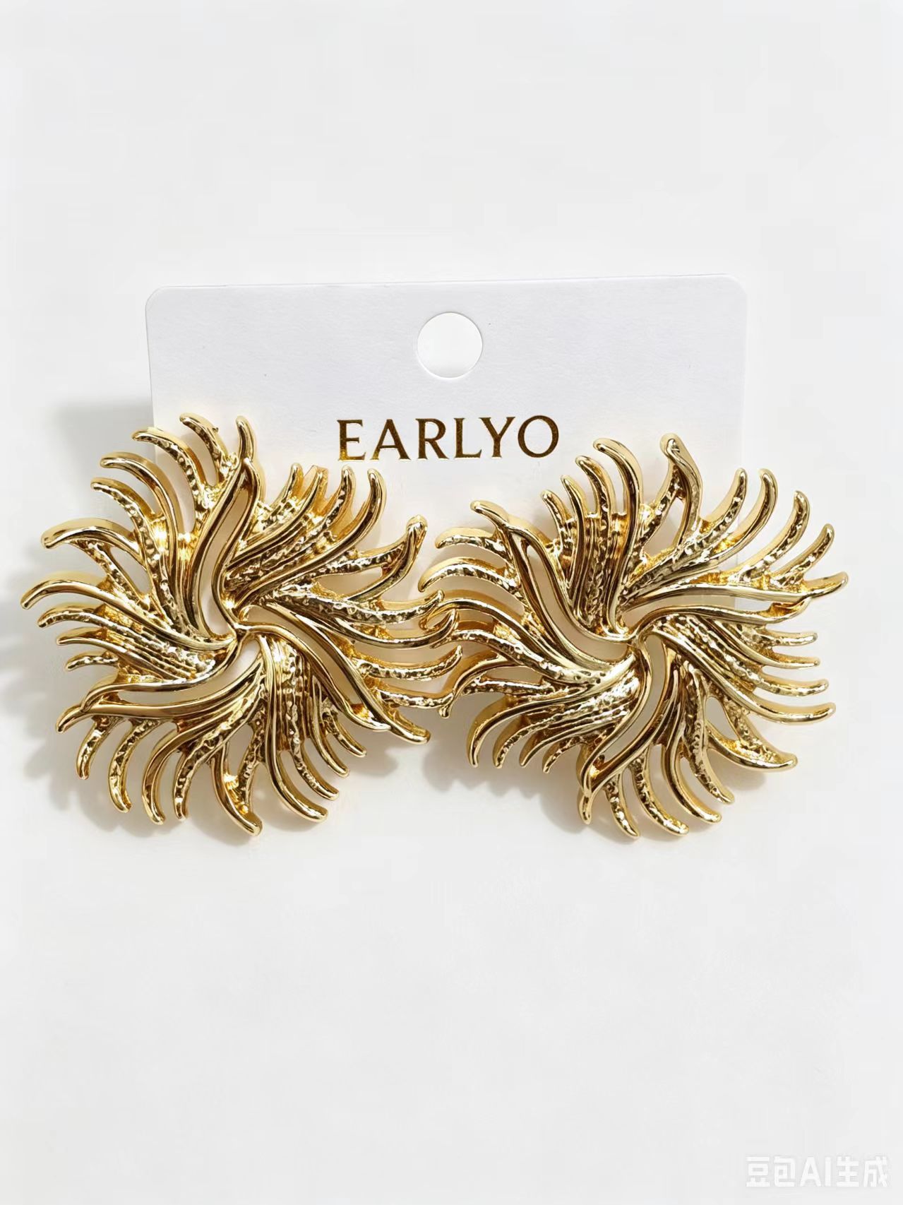Gold sunburst earrings with spiral center and radiating rays, statement jewelry